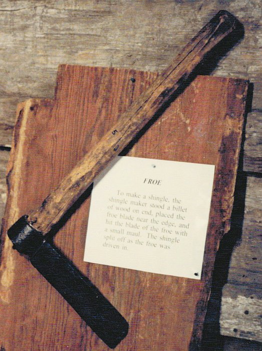 A froe is a
              cleaving tool for splitting shingles from a block of wood.
              This close-up photograph shows the handmade handle on this
              froe.